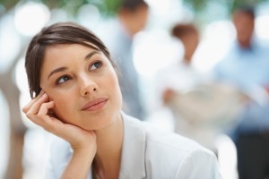 Day dreaming - Pretty Caucasian business woman with hand on chin